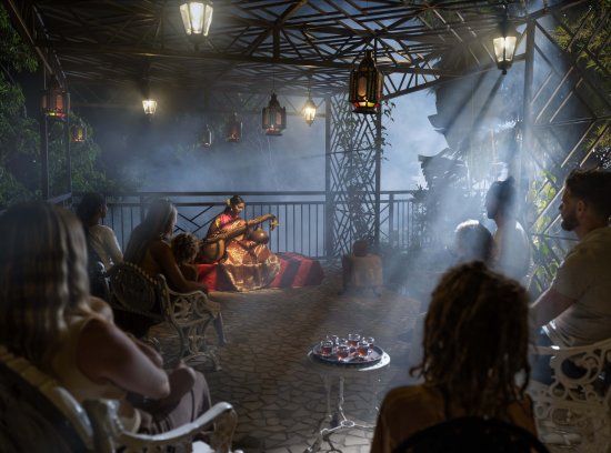 he ambience is enhanced by traditional ragas played on the Veena, with guests from various regions